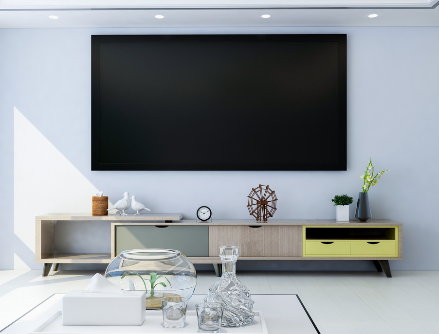 TV and TV cabinet in modern living room, there are many decorations on TV cabinet